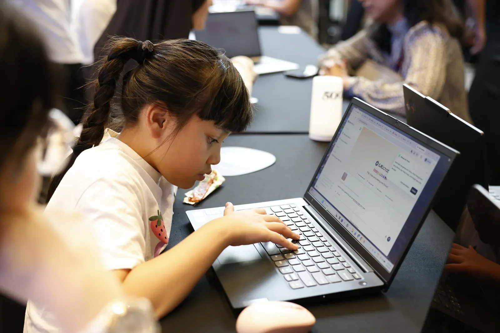 A child using ILMUchat on a laptop during the AI Learn-a-thon