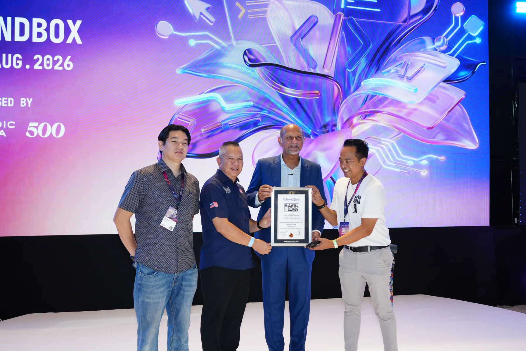 Organisers holding the framed Malaysia Book of Records certificate on the AI Malaysia Takeover stage