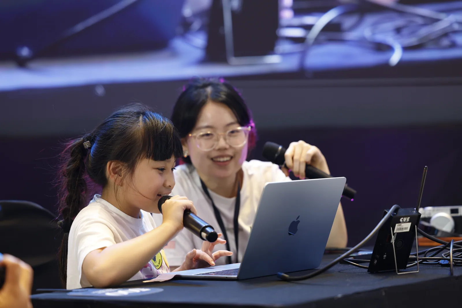 An eight-year-old participant demonstrating the project she built during the Learn-a-thon