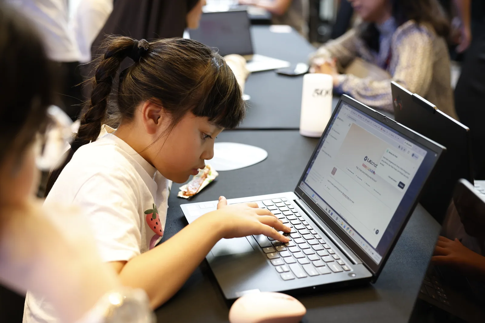 A child using ILMUchat on a laptop during the AI Learn-a-thon